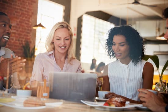 Businesspeople Meeting In Coffee Shop Shot Through Window